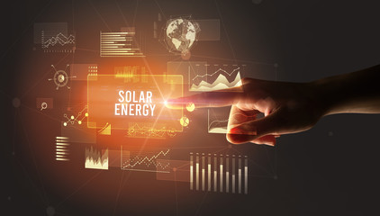 Hand touching SOLAR ENERGY inscription, new business technology concept