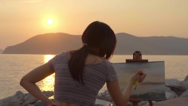 Asian artist painter who paint a sunrise, slow motion, CINE color/vintage