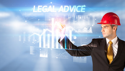 Handsome businessman with helmet drawing LEGAL ADVICE inscription, architecture business plan concept