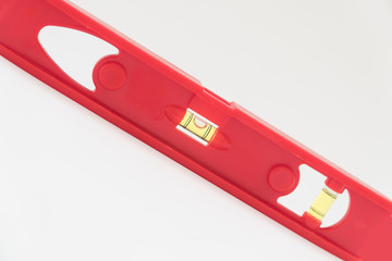 Red level tool used for determinig the level of a surface for construction .