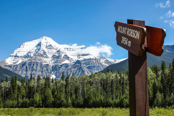 Mount Robson with a wooden sign to the top in early spring season daytime, Mount Robson Provincial...
