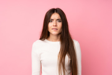 Fototapeta premium Young woman over isolated pink background having doubts and with confuse face expression