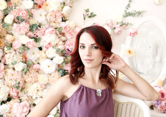 Young girl on a background of spring flowers