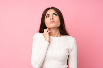 Young woman over isolated pink background thinking an idea