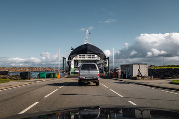 Cars driving on the ferry at Mortavika that is transporting them to Arsvågen, Norway - 318026692