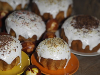 Easter. Cooking Easter cakes at home. Easter baking with natural sprinkles and colored eggs on a wooden ancient background.