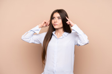 Young woman over isolated background having doubts and thinking