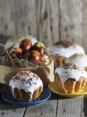 Easter. Cooking Easter cakes at home. Easter baking with natural sprinkles and colored eggs on a wooden ancient background.
