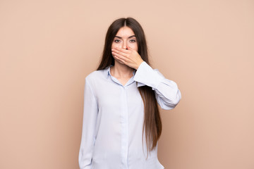 Young woman over isolated background covering mouth with hands