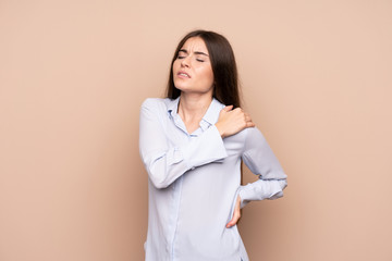 Young woman over isolated background suffering from pain in shoulder for having made an effort