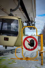 Cableway Station with Close Up of Stop Signage in Winter