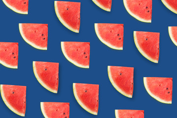 Watermelon slises on classical blue background. Summer concept. Top view. Flat lay. Fruit pattern
