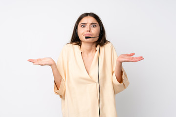 Young telemarketer woman over isolated white background having doubts with confuse face expression