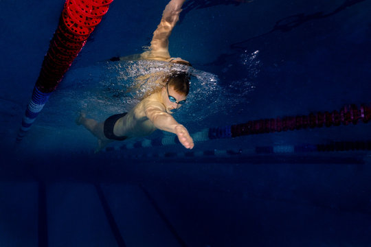 male athlete in a swimming competition swims in the pool. scuba diving, swimmer goggles for swimming and swimming