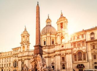 Fototapeta na wymiar Navona Square in sunlight, Rome, Italy. Sant'Agnese church and Four Rivers fountain with Egyptian obelisk. Piazza Navona is famous tourist attraction of Rome.