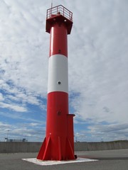 Red lighthouse on a summer sunny day.