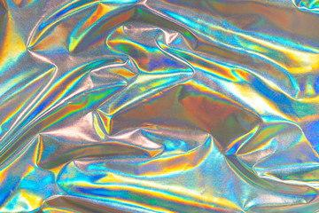 Iridescent fabric trendy holographic background. Colorful chrome fabric.