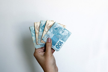 Hands holding Brazilian real notes - Money from Brazil - Notes of Real - Brazil BRL banknote