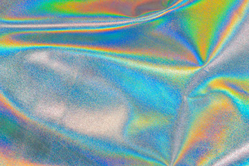 Iridescent fabric trendy holographic background cloth. Colorful chrome fabric.