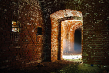 Fototapeta na wymiar Light at the end of tunnel. Passage in abandoned German fortification