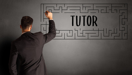 businessman drawing maze with TUTOR inscription, business education concept