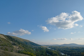 Fototapeta na wymiar Hillside with blue sky and clouds