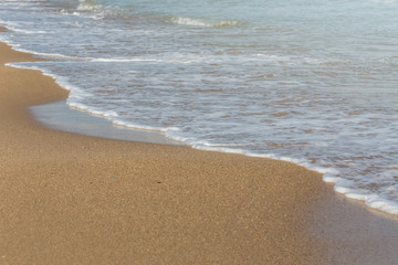 Soft wave of blue ocean on sandy beach. Background. Nature concept. 