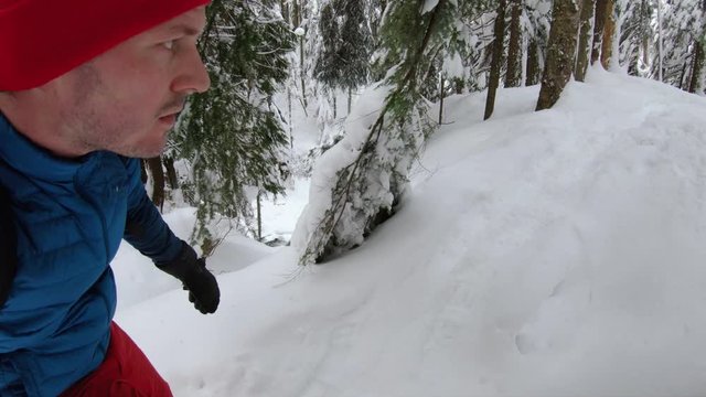 Man Exploring Winter Wonderland Forest on Snowshoe Adventure