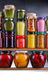 Jars with variety of pickled vegetables and fruits