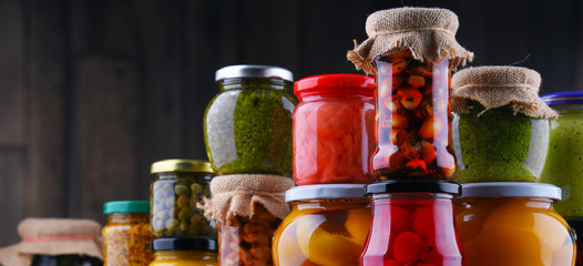 Jars with variety of pickled vegetables and fruits