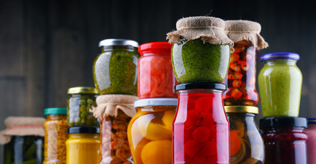 Jars with variety of pickled vegetables and fruits