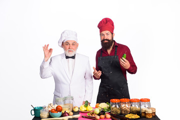 Chef. Two chefs on kitchen. Healthy food. Professional culinary. Bearded man in kitchen apron. Bearded man chef in uniform. Cook. Ready to cook. Healthy lifestyle. Diet. Health care.