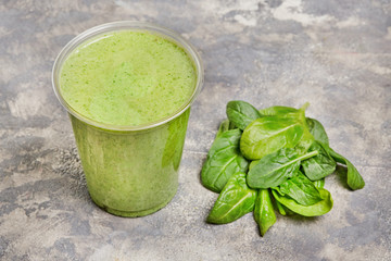 Fresh Spinach Leaves smoothie on a gray concrete background. Top view.