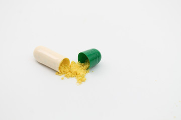 open capsule on white background