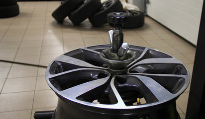 Fototapeta na wymiar Wheel Rim Balanced In A Tire Workshop