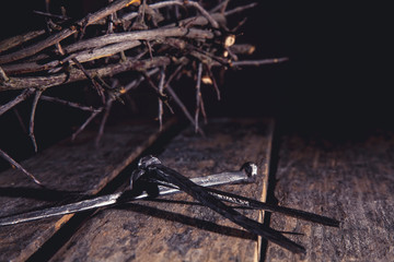 Close up bloody nails and crown of thorns as symbol of passion, death and resurrection of Jesus...