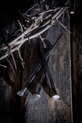 Crown of thorns and nails again vintage wooden background passion, death and resurrection of Jesus Christ. Selective focus on nails.