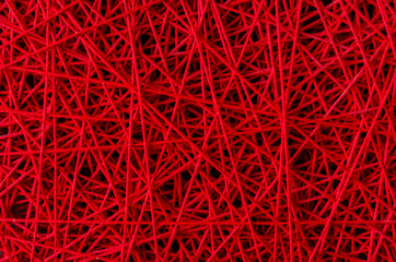 Abstract texture of interwoven red threads