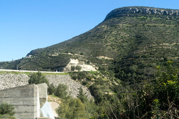 Fototapeta na wymiar Green hill and overflowing Germasogeia dam, Cyprus