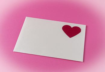 Celebration greeting card on a pink background with red heart. Valentine's Day background. 