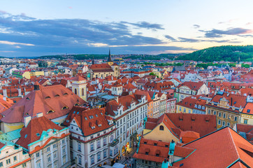 Fototapeta na wymiar Top aerial panoramic view of Prague Old Town (Stare Mesto) historical city centre with red tiled roof buildings and Petrin hill garden in evening sunset, Bohemia, Czech Republic