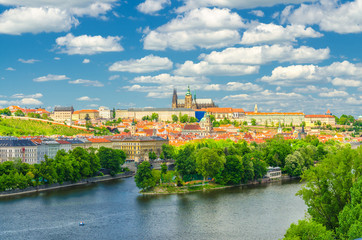Fototapeta premium Aerial panoramic view of Prague city, historical center with Prague Castle, St. Vitus Cathedral in Hradcany district, Strelecky island, Vltava river, blue sky white clouds, Bohemia, Czech Republic