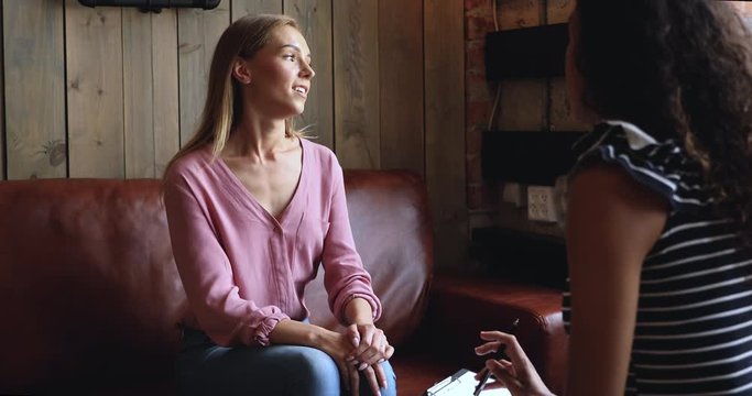 Attractive young woman meeting african american psychologist.
