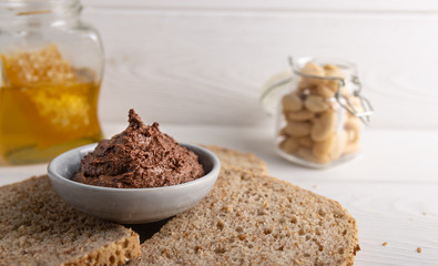 Homemade organic vegan chocolate spread, made of almonds, honey and cacao. With a jar of rice milk