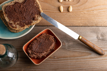 Homemade organic vegan chocolate spread, made of almonds and organic cacao and honey. Top view.