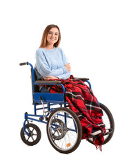 Handicapped young woman in wheelchair on white background