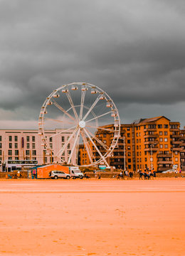 Ferris Wheel In Amusement Park Against Cloudy Sky