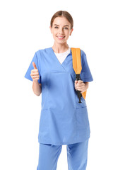 Female medical student showing thumb-up gesture on white background