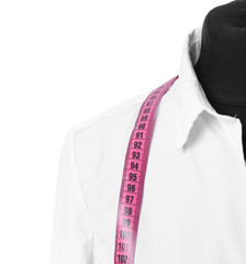 Mannequin with shirt and measuring tape on white background