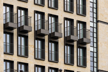 Obraz premium fragment of a facade of a Windows and balconies on the building.
